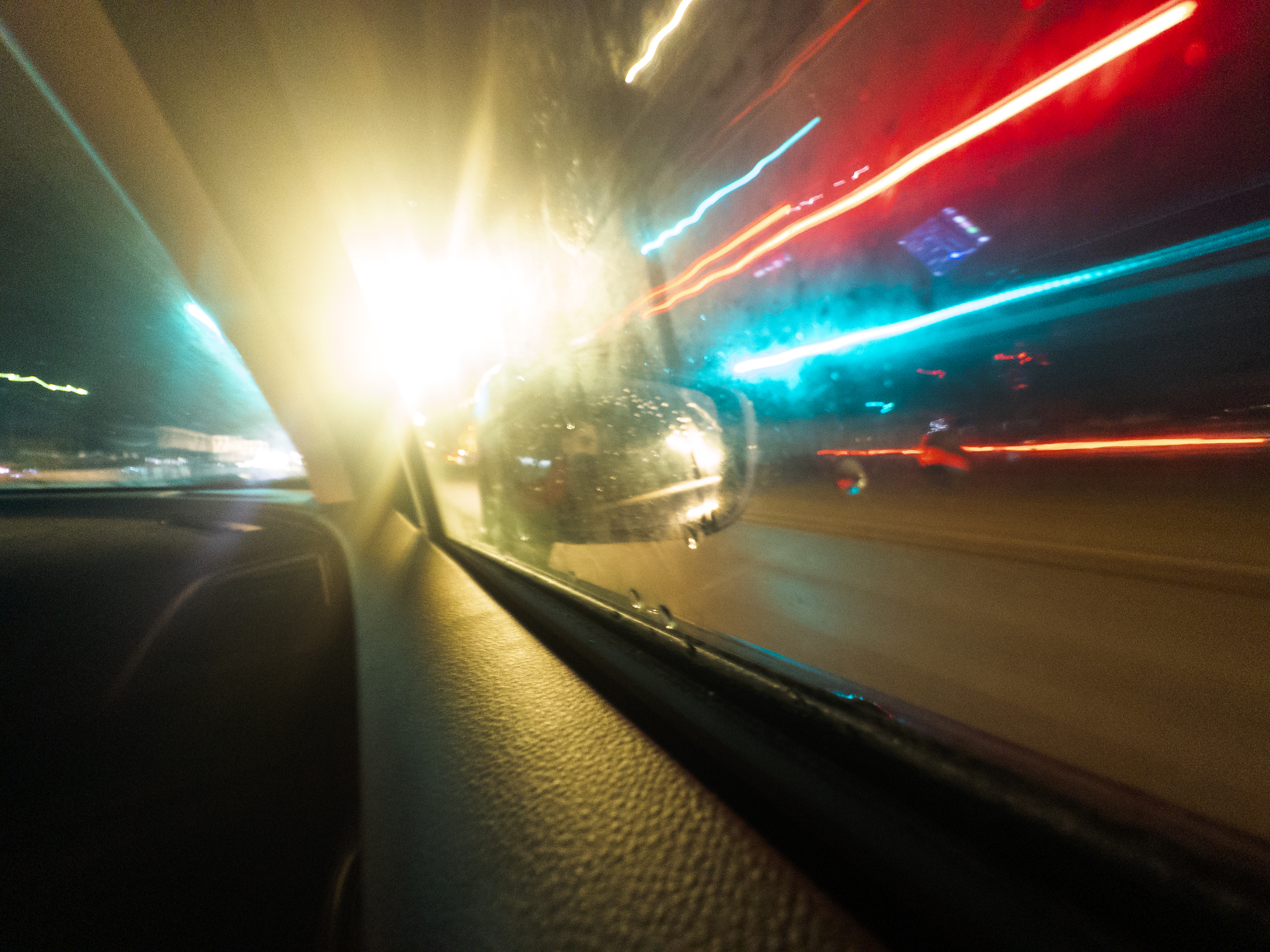 a kinda long exposure picture taken while driving at night through an intersection